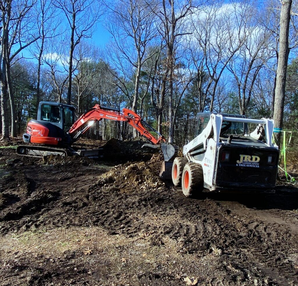 JRD Landscape Design equipment preparing a Weymouth, MA landscape construction site before hardscape installation.