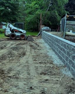 Concrete block retaining wall under construction on a South Shore landscape project