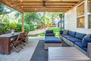 A shaded backyard patio with light pavers stays cool during a hot South Shore summer.