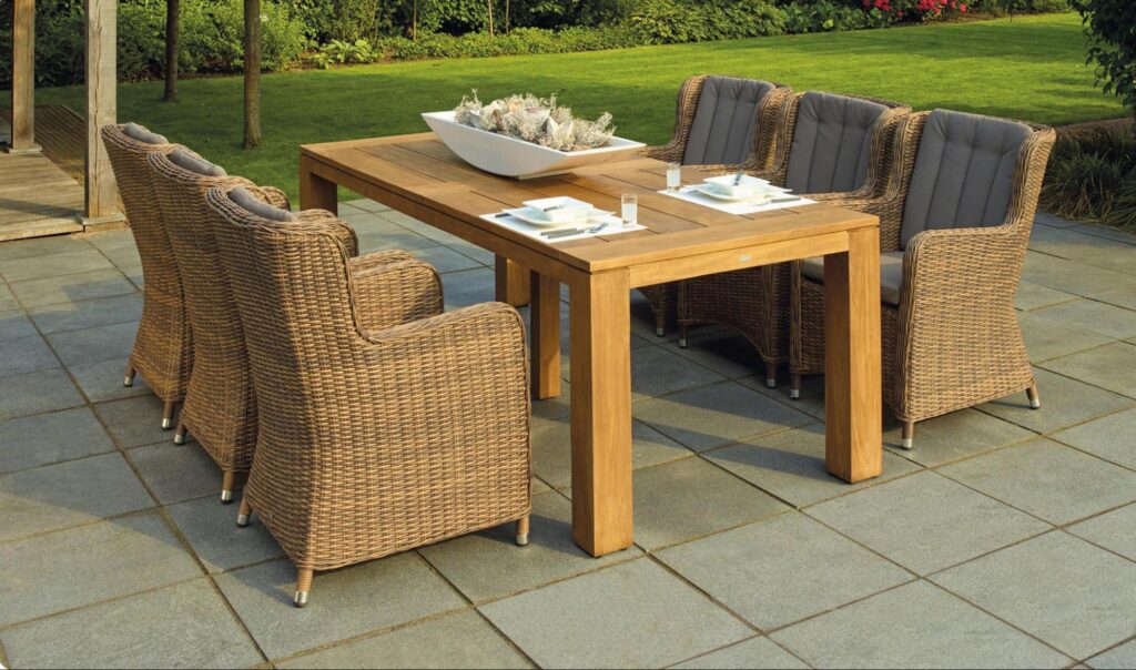 A large-format stone outdoor patio with a dining area at a Marshfield, MA home.